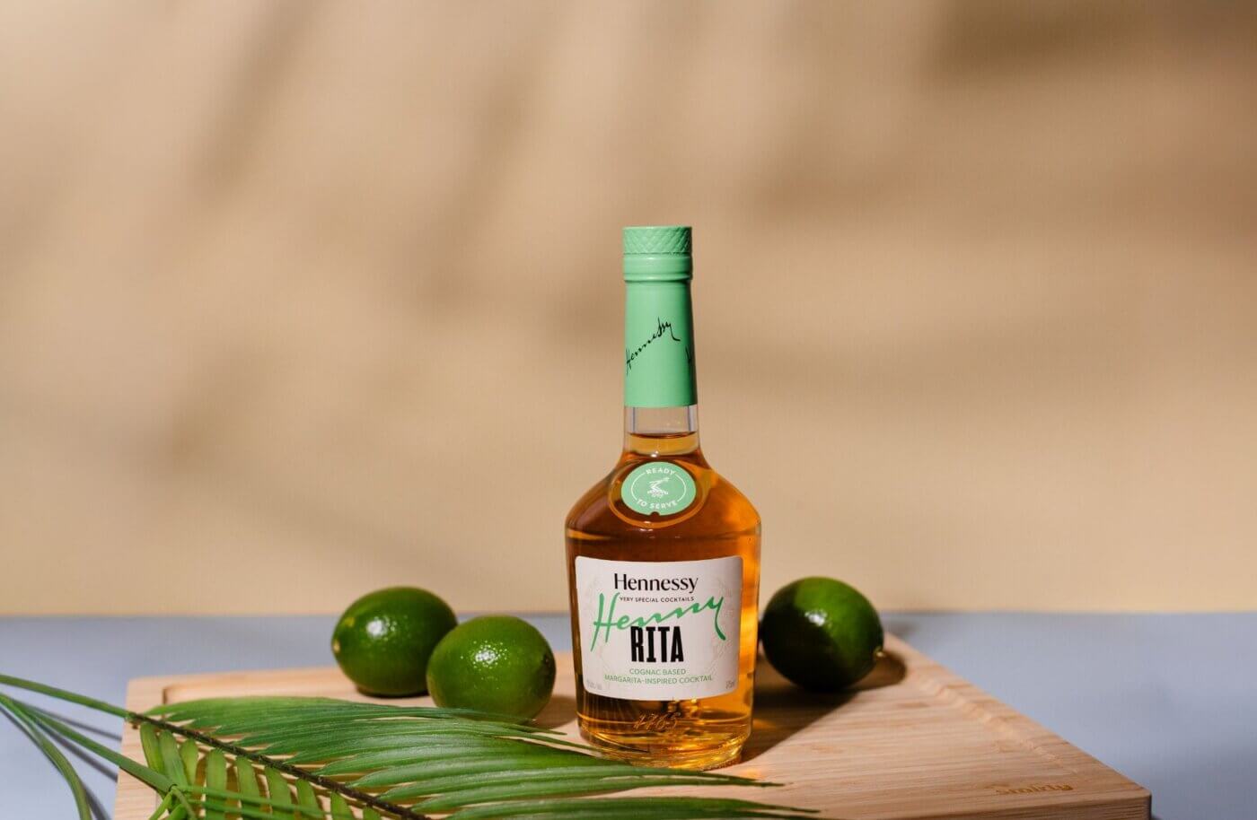 Hennessy Rita Inspired Cognac Cocktail Bottle with limes around it